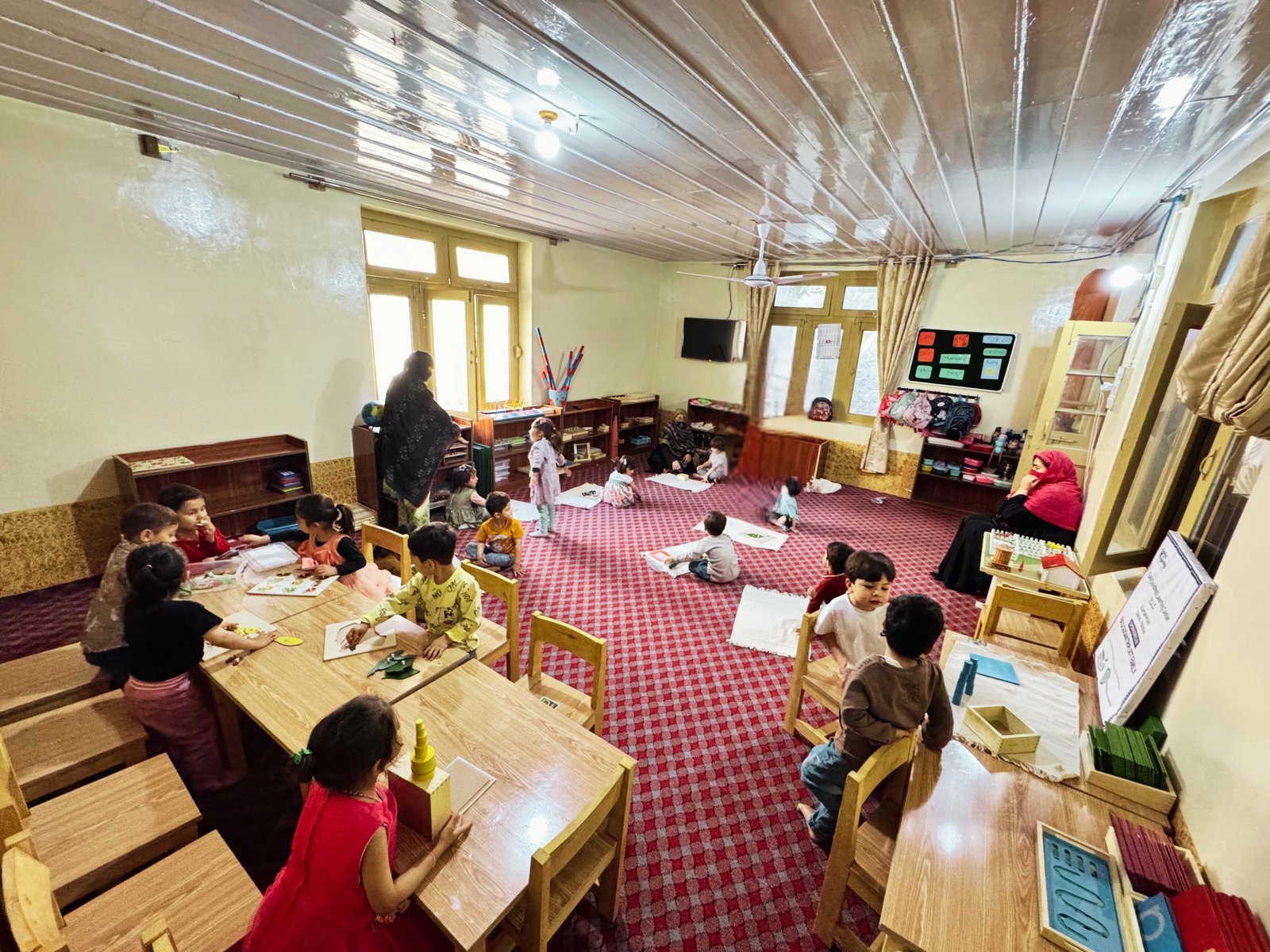A Montessori teacher working with young children at a Bright Beginnings learning center, Chitral