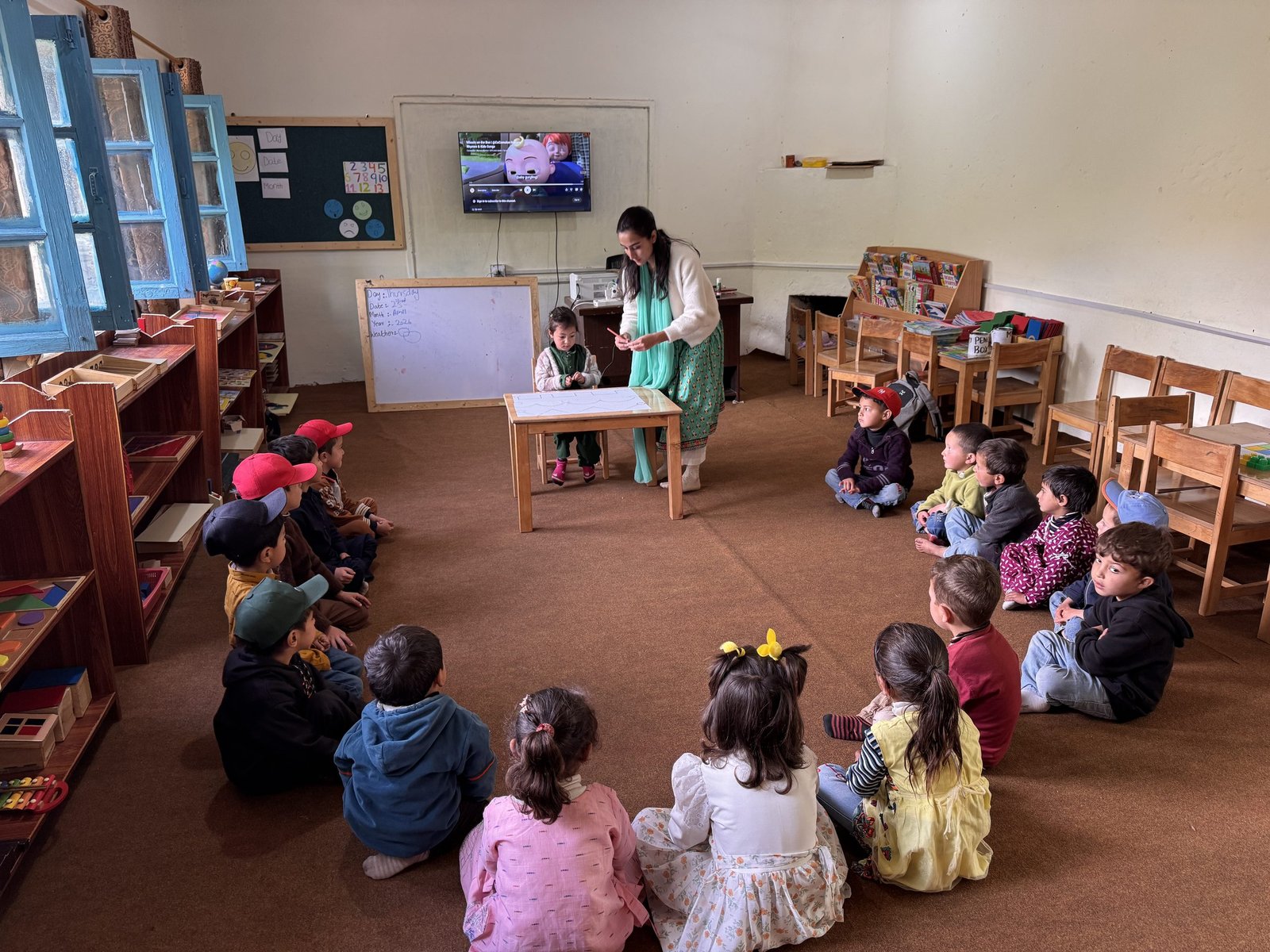 Children take turns practicing at the front of the class during circle time.