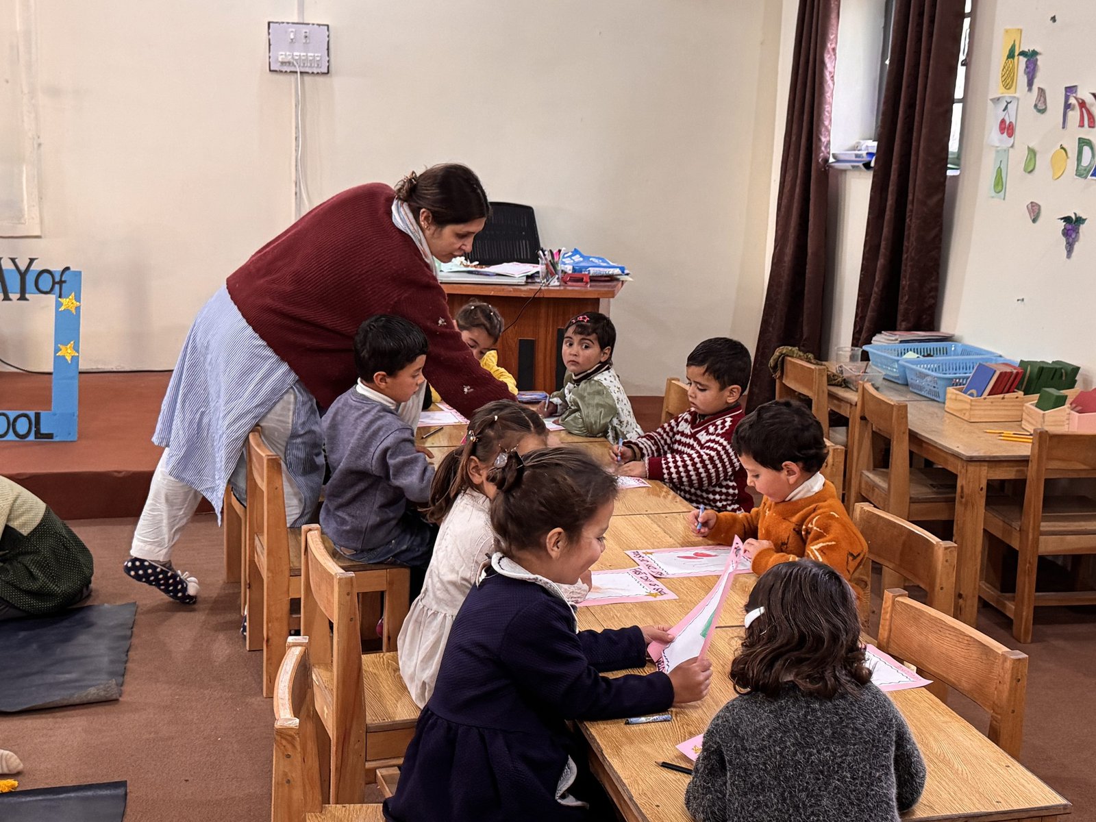 Children settle into their first day of school with a drawing activity.