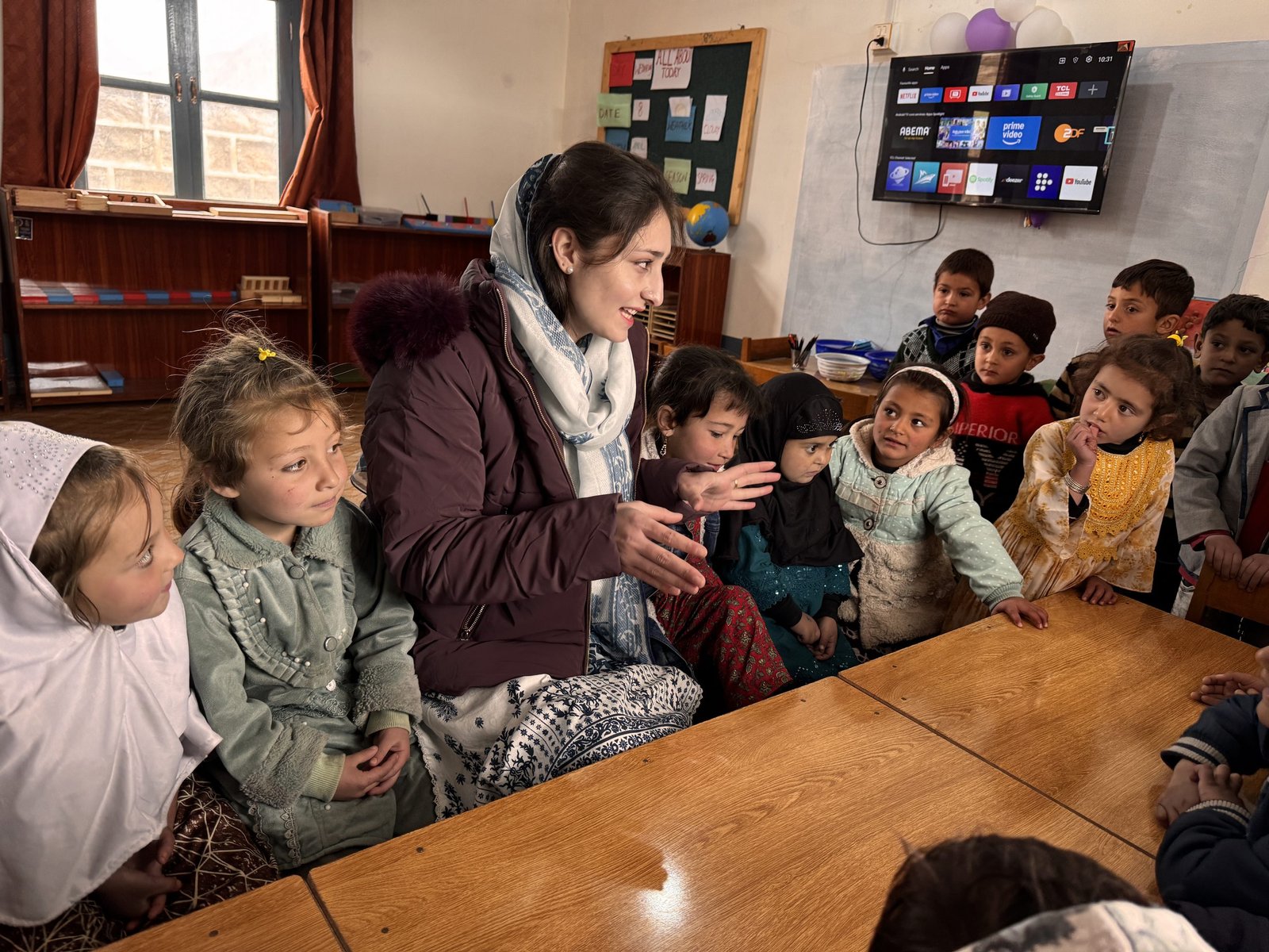 A WEF team member spends time with children at an Early Childhood Learning Center.